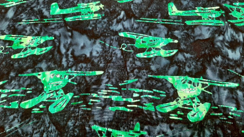 Batik Fabric In A Green Airplane Print - Christina's Fabrics Online Superstore. Shop now