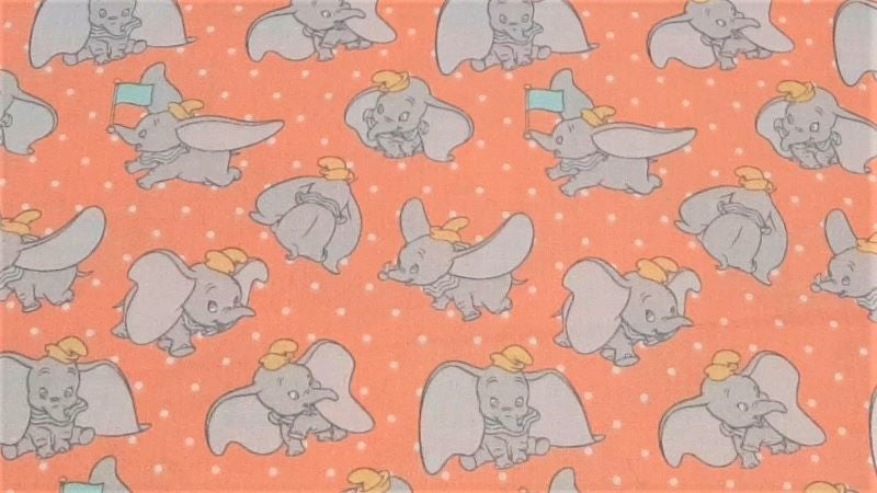 Cotton Disney Fabric Dumbo The Elephant In A Pretty Coral Color - Christina's Fabrics Online Superstore. Shop now