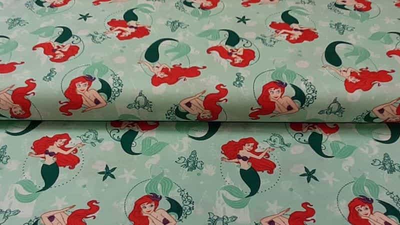 Cotton Fabric In Green With Disney's Little Mermaid Print - Christina's Fabrics Online Superstore. Shop now